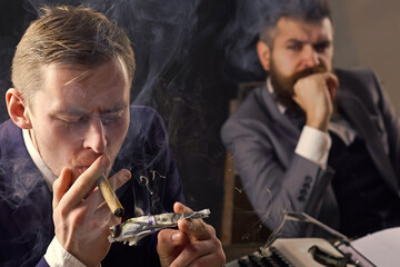 Man lighting cigar from burning dollar banknote. Business meeting. Gangster and money. Concept of...