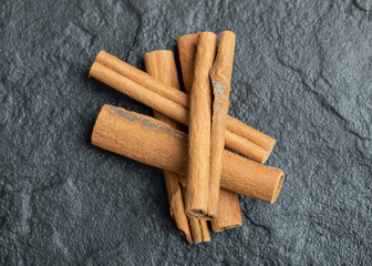 Top view of cinnamon sticks isolated on dark background