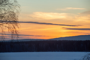 Beautiful scenery of sundown on frosty winter evening in the countryside