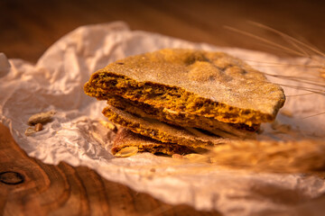 Made by hand fresh tortillas on parchment paper on the wooden table