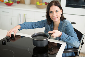 disabled woman cooking meal at home
