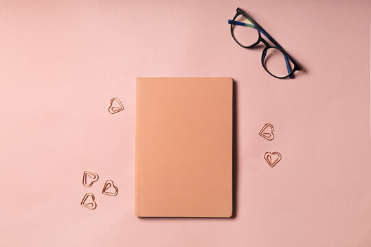 Pink diary on pink background