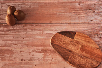 Several kiwis on wooden board