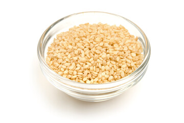 Sesame seeds in a glass bowl, isolated on white background. High resolution image