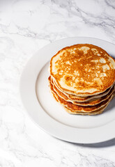 Stack of pancakes on white marble backgorund