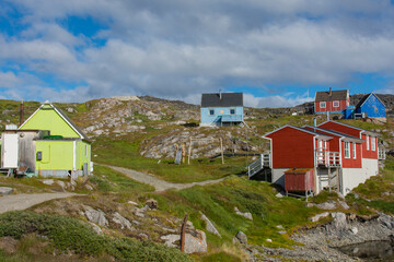 Fototapeta na wymiar Greenland. Itilleq. Colorful houses dot the hillside.