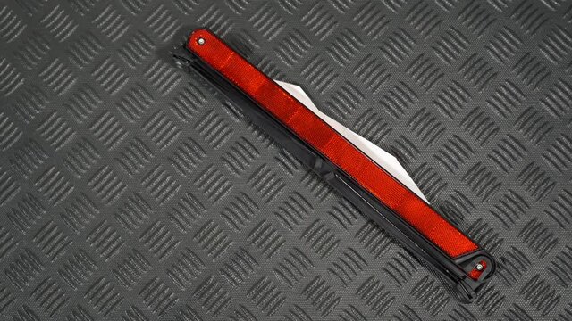 Closeup top view flatlay 4k stock video footage of male hand taking red triangle warning sign laying on black plastic rubber mat in boot of automobile