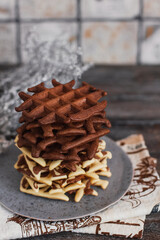Fototapeta na wymiar Traditional Belgian waffles with cocoa on wooden background, homemade healthy breakfast.