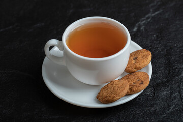 A cup of aroma tea with delicious cookies