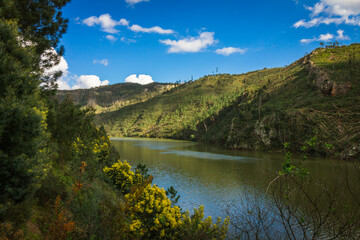 Landscape view of the lake with mountains background and beautiful clouds on the sky. Landscape view of Zezere river in Aldeias de Xisto, Portugal