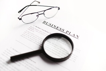Business plan scrutiny concept. Flat lay on white table.