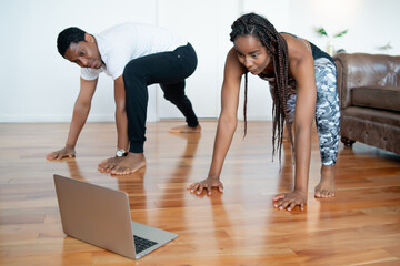 Couple doing exercise together at home.