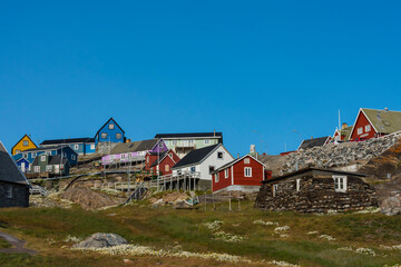 Fototapeta na wymiar Greenland. Uummannaq. Colorful houses dot the rocky landscape.