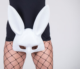 Wearing a white mask. Sensual woman legs. Mask. Sexy photo. 