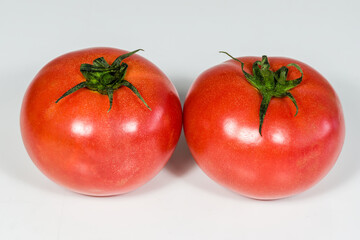 ripe red raspberry tomatoes on white background