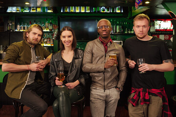 Friends drinking beer in pub