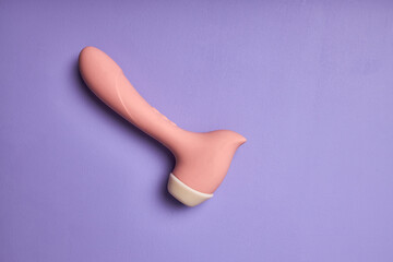 Erotic pleasure toy on purple background. Sex toy for adult, design minimal dildo vibrator for clitoris. Minimal concept. Copy space