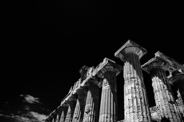 The Temple of Hera (Temple E) at Selinunte, Sicily (Italy). Columns of the Doric Greek Temple stand out against the black sky. Black and white with red filter.