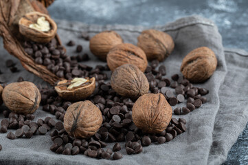 Healthy walnuts with chocolate chips on a gray tablecloth