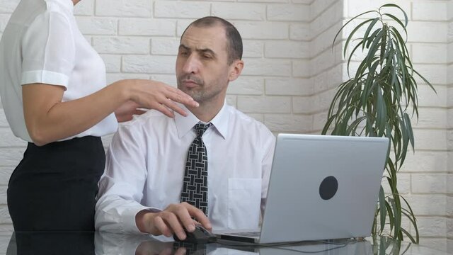 love affair in the office. A businessman keeps a distance in communication with a secretary in the office.