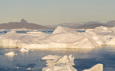Iceberg in the Uummannaq Fjord System. Glaciated Nuussuaq peninsula in the background. Greenland,...