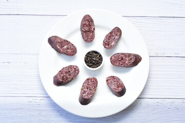 Morcilla Antioqueña, traditional Colombian sausage, covered with lemon and pepper on wooden...