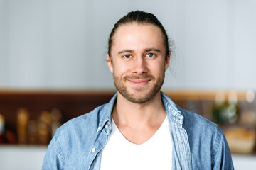 Close-up portrait of a handsome attractive caucasian guy, student or freelancer. Stylish young man...