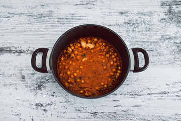 vegan chickpea mushroom red pesto sauce in pot, healthy plant-based food