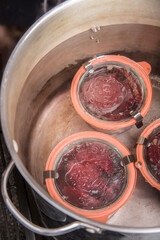 Weck canning jars of pickled beets being processed in a boiling water bath.