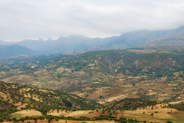 Fototapeta na wymiar Moroccan landscape with foggy mountains and fields.