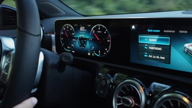 Close up futuristic car dashboard with graphics and speedometer 