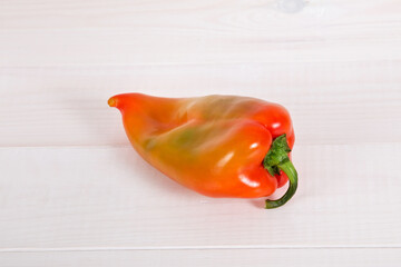 Bulgarian sweet bell pepper on white wooden background.