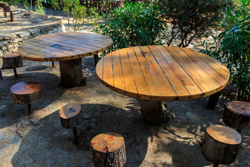 Empty rustic round wooden table and stools in park  in Kemer, Turkey