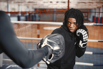 Obraz na płótnie Canvas African sporty man boxing. Mixed people training.