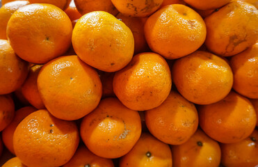 Orange fruits in the fruit market. Fresh fruit for juicy drinks. 