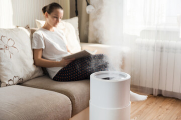 Modern air humidifier, aroma oil diffuser at home. Improving the comfort of living in a house,...