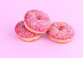 Three pink donuts with small candies