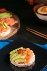 Puffed rice spread with raw salmon and avocado