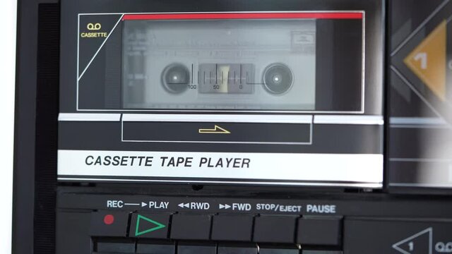 Vintage Cassette tape being put into a retro cassette player 4K