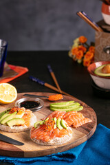 Fototapeta na wymiar Puffed rice spread with raw salmon and avocado