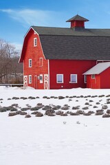 View of a traditional red barn in winter after a snowfall in New Jersey, United States