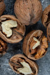 Half cut organic walnuts on marble background