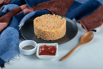 Delicious bulgur pilaf on a dark plate