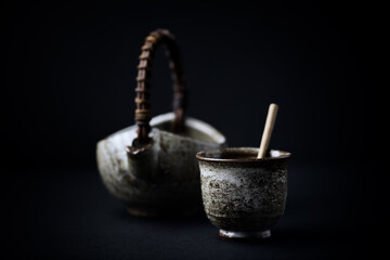 Traditional, handcrafted ceramic on dark background. Soft focus. Close up