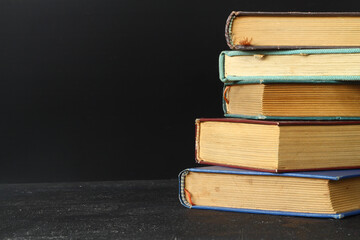Close-up of stack of old used books background. Pile of vintage old hardback books. Back to school....