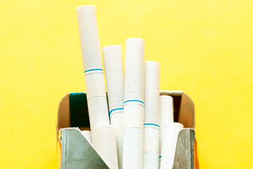 Box of cigarettes at yellow . Unhealthy Lifestyle