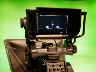 abstract blurred of broadcast camera in studio with virtual greenscreen at TV station.

