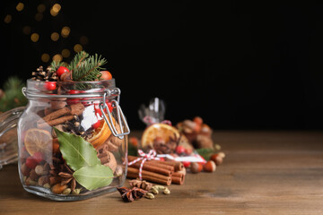 Aroma potpourri with different spices on wooden table, space for text