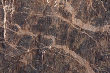 White Streaks In the Layered Rock Wall In Black Canyon