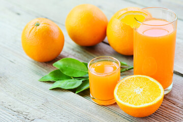 Fresh orange juice in the glass with orange fruit on wooden background, healthy fruits and orange slice
